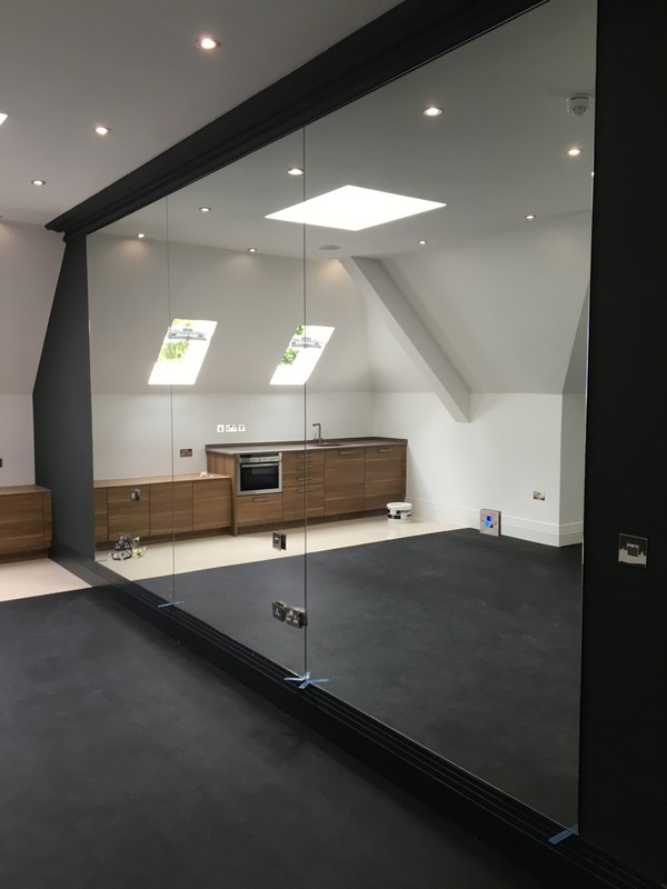 Frameless glass partition in loft conversion by Wandsworth glaziers