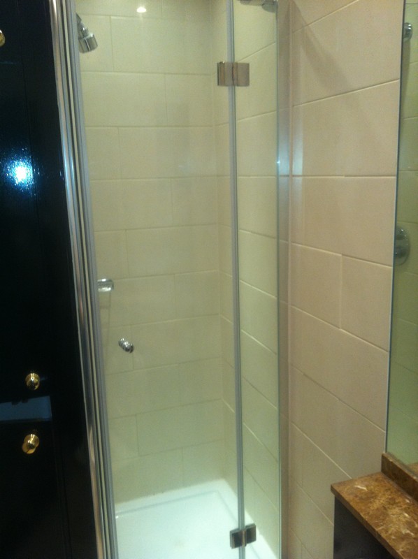 Frameless glass shower enclosure with chrome fittings in Wandsworth